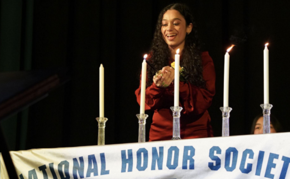 Philanthropy Chair, Sofia Shilleh lights the candles. Photo by Portraits USA.